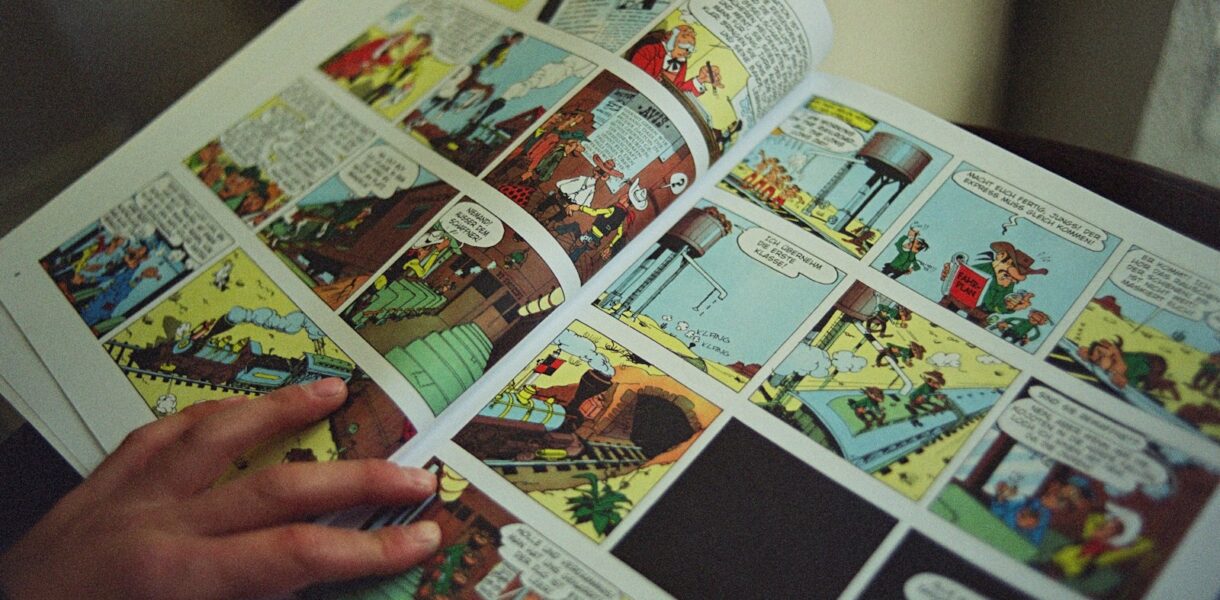 person holding white and black magazine