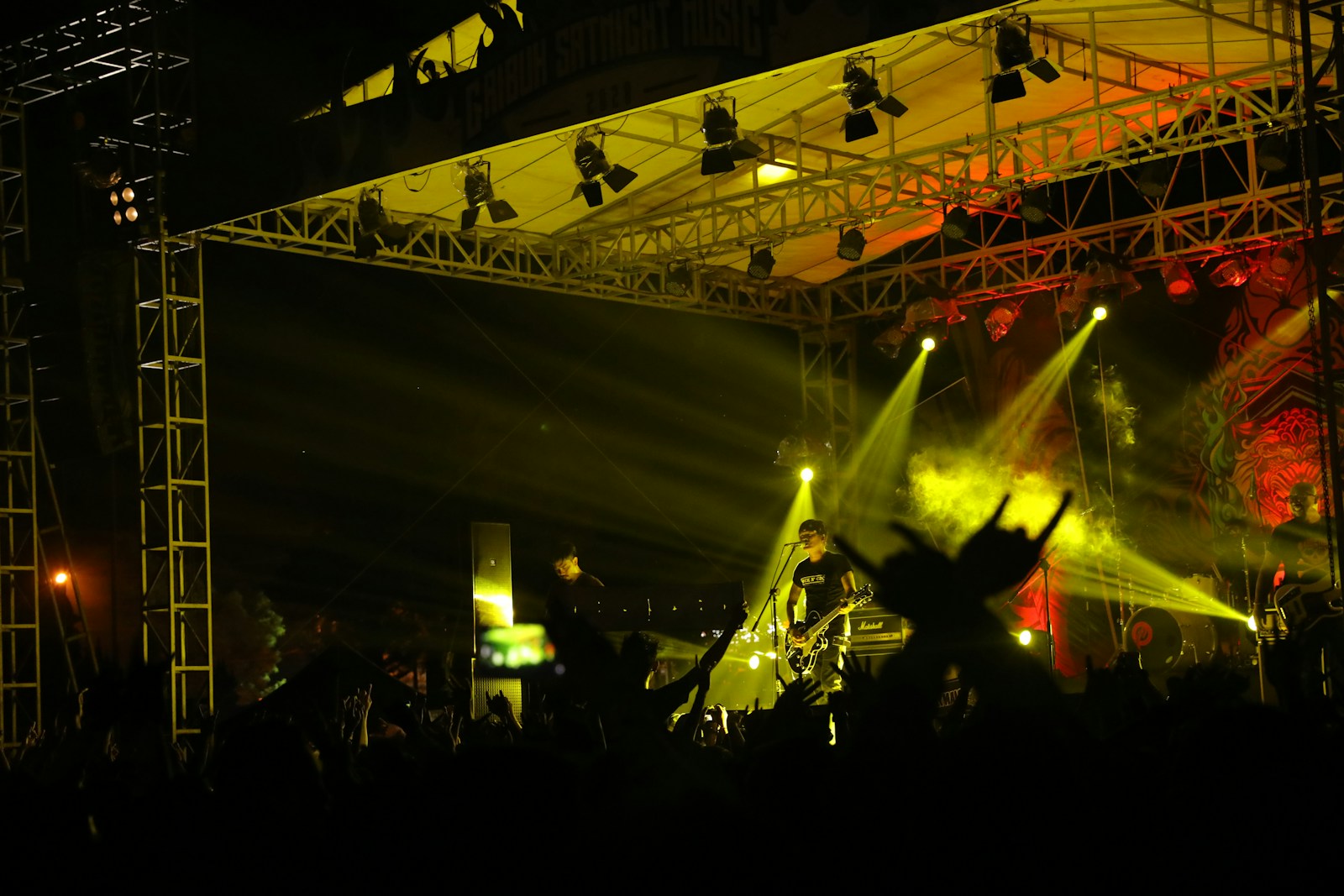 a crowd of people standing on top of a stage