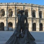 a statue of a man in front of an old building