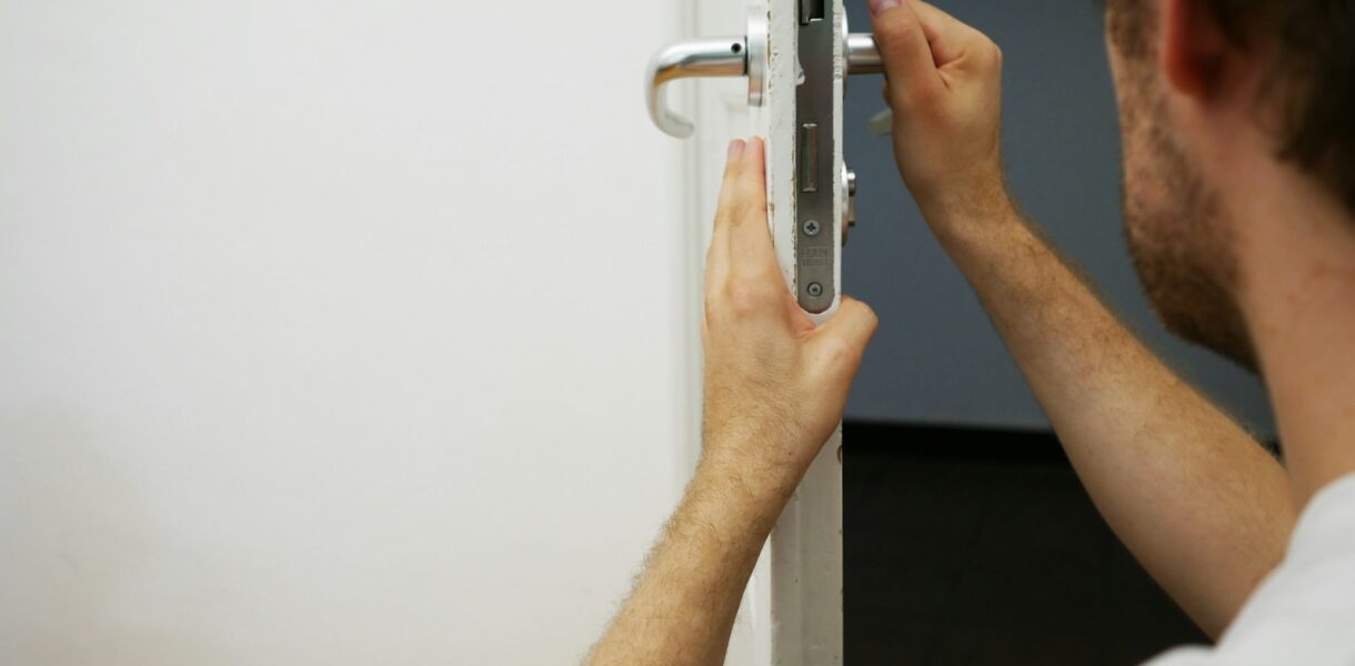 person holds door lever