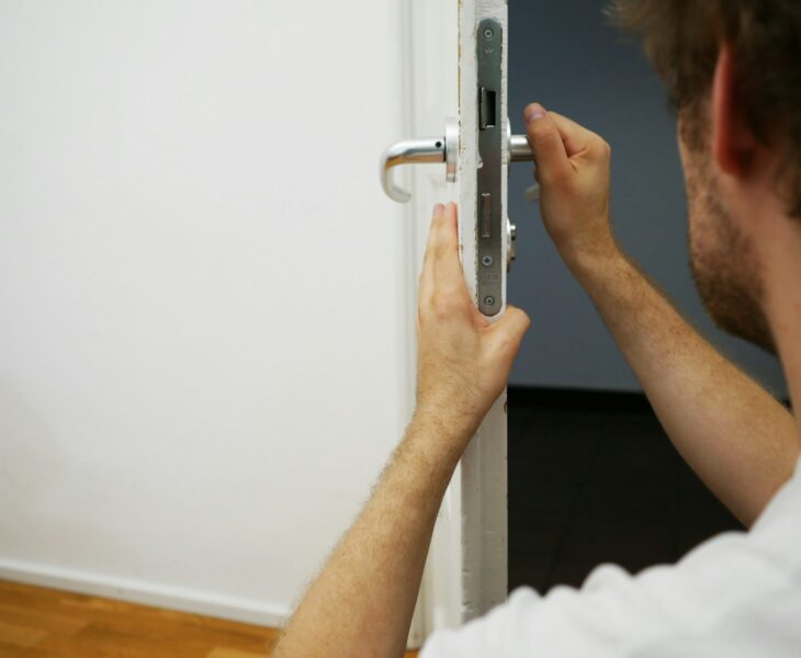 person holds door lever